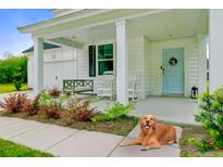 Charming front porch with swing, rocking chairs, landscaping, and a light blue door at 1226 Spotflower St, Summerville, SC 29485