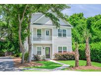Charming two-story home with a quaint front porch and lush landscaping in a desirable location at 1242 Schirmer St, Mount Pleasant, SC 29464