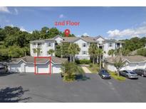 Condominium exterior showing a view of second story units with garage parking on the ground level at 1300 Park West Blvd # 106, Mount Pleasant, SC 29466