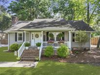 Charming single-story home with inviting front porch, brick stairs, lush landscaping, and mature trees at 1337 Old Fort Rd, Moncks Corner, SC 29461