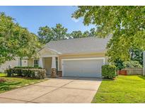 Charming single-story home with a well-maintained lawn, driveway, and two-car garage at 139 Gaslight Blvd, Summerville, SC 29483