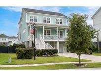 Charming two-story coastal home with a welcoming front porch and well-manicured lawn at 1464 Stratton Pl, Mount Pleasant, SC 29466