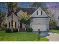 Charming two-story home featuring a manicured front lawn and attached two-car garage at 2050 S Smokerise Way, Mount Pleasant, SC 29466