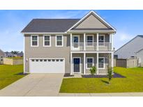 Charming two-story home with a welcoming front porch and a two-car garage, nestled in a serene neighborhood at 240 Lucca Dr, Summerville, SC 29486