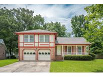 Charming two-story home with a well-maintained lawn and a two-car garage, exuding curb appeal at 2425 Vistavia Rd, North Charleston, SC 29406