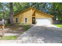 Charming home featuring a two-car garage and an expansive front yard, perfect for Gathering living at 2831 Chicopee Dr, North Charleston, SC 29420