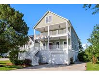Two-story coastal style home with dual balconies and white railings at 3095 S Shore Dr, Charleston, SC 29407