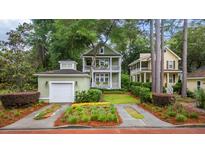Charming two-story home with a garage, landscaped yard, and inviting double porches at 3221 Johnstowne St, Johns Island, SC 29455