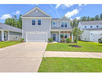 Charming two-story home featuring a well-manicured lawn and attached garage, perfect for suburban living at 4314 Cotton Flat Rd, Summerville, SC 29485