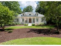 Charming white brick home featuring a landscaped front yard, columns, and a welcoming front porch at 441 Elfes Field Ln, Charleston, SC 29492
