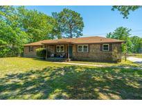 Charming brick ranch-style home with a covered front porch and a well-maintained yard at 565 Estates Dr, Walterboro, SC 29488
