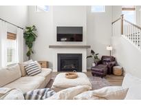 Comfortable living room with a fireplace, plush sofa, and staircase at 102 Bolsena Ct, Summerville, SC 29486