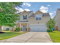 Charming two-story home with a well-manicured lawn, a two-car garage, and inviting curb appeal at 1052 Whitlow Blvd, Summerville, SC 29483