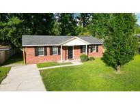 Charming single-story brick home featuring a well-manicured lawn and classic black shutters at 109 Ashdown Dr, Summerville, SC 29483