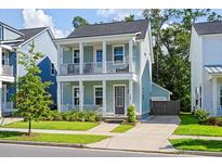 Charming two-story home with a inviting double porch, lush landscaping, and private driveway at 109 W Respite Ln, Summerville, SC 29483