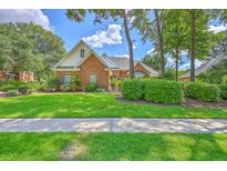 Charming brick home features a lush green lawn and mature trees, creating inviting curb appeal at 109 Waveney Cir, Goose Creek, SC 29445