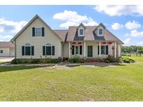 Charming two-story home with a covered front porch and beautifully landscaped front yard at 1111 Sandy Springs Circle, Walterboro, SC 29488