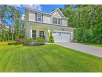 Charming two-story home with a well-maintained lawn and attached two-car garage at 115 Cooper Dr, Summerville, SC 29483