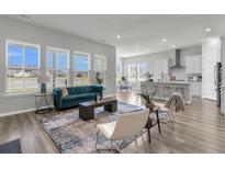 Bright, open living area features large windows, modern decor, and an eat-in kitchen with bar seating at 1213 Locals St, Summerville, SC 29485