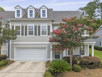 Charming townhome with a two-car garage and a well-manicured front yard at 132 Fresh Meadow Ln, Mount Pleasant, SC 29466