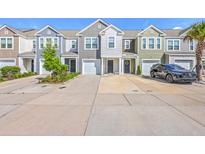Charming townhomes feature colorful siding, well-manicured landscaping, and private driveways at 166 Rosefield Ct, Summerville, SC 29485