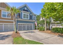 Charming blue two-story townhouse featuring an attached two-car garage and a meticulously maintained front yard at 2036 Kings Gate Ln, Mount Pleasant, SC 29466