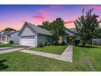 Charming single story home with landscaped front yard and attached two-car garage at 207 Apache Dr, Summerville, SC 29483