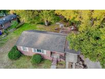 Aerial view of a charming brick house with a well-maintained roof, lush landscaping, and mature trees at 2736 Star Drive, North Charleston, SC 29406