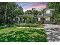 Charming home with a landscaped front yard, walkway, and mature trees at 3002 Waterway Blvd, Isle of Palms, SC 29451