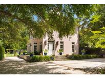 Stately home features a stucco exterior, mature trees, manicured landscaping, and a spacious driveway at 429 Venning St, Mount Pleasant, SC 29464