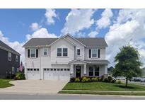 Charming two-story home with a two-car garage, beautiful landscaping, and a welcoming front porch at 558 Pendleton Dr, Moncks Corner, SC 29461