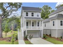 Charming two-story home featuring a welcoming front porch and a convenient drive-under garage at 615 Du Bois Dr, Johns Island, SC 29455