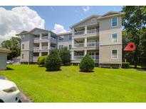 Lovely condo building with well-maintained lawn and inviting balconies on a bright day at 700 Daniel Ellis Dr # 3108, Charleston, SC 29412