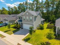 Beautiful two-story home with a well-manicured lawn, attached garage, and inviting curb appeal at 704 Kilarney Rd, Summerville, SC 29483
