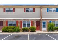 Inviting townhome featuring red and blue shutters, green landscaping and convenient parking at 107 Hickory Ln # C, Ladson, SC 29456