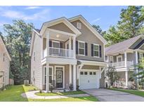 Charming two-story home with a welcoming front porch and a well-maintained lawn at 153 Instructor Ct, Ladson, SC 29456