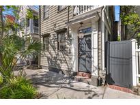 Charming home entrance with gray door, brick steps, and classic lantern fixture adding a touch of elegance at 176 Smith St, Charleston, SC 29403