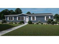 Charming single-story home with blue siding, white trim, a well-manicured lawn, and a paved walkway at 313 Marion Rd, Dorchester, SC 29437