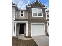 Charming two-story home with a one car garage, neutral siding, and a welcoming entrance at 4669 Palm View Cir, North Charleston, SC 29418