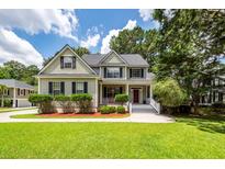 Charming two-story home with a welcoming front porch and well-maintained landscaping at 477 Commonwealth Rd, Mount Pleasant, SC 29466