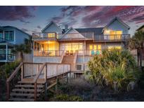 Expansive multi-story home with multiple decks and stairs leading down to the beach at 505 E Arctic Ave, Folly Beach, SC 29439