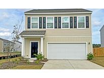 Charming two-story home featuring black shutters, a built-in garage, and manicured landscaping at 549 Pender Woods Dr, Summerville, SC 29486