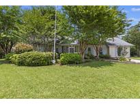 Charming single-story home with a well-manicured lawn and mature trees offering shade and curb appeal at 604 Longstreet St, Summerville, SC 29486
