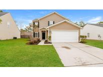 Charming two-story home with a well-maintained lawn and a two-car garage at 8285 Little Sydneys Way, North Charleston, SC 29406