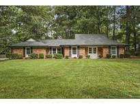 Charming brick home with well-manicured lawn and mature trees offering classic curb appeal at 96 King Charles Cir, Summerville, SC 29485