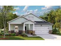 Charming single-story home featuring a two-car garage, covered porch, and a beautifully landscaped front yard at 106 Barker Street, Summerville, SC 29486