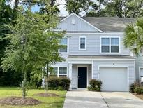 Charming two-story home featuring a well-maintained lawn, attached garage, and classic light-grey siding at 109 Rosefield Ct, Summerville, SC 29485