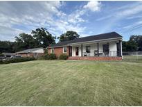 Charming single story home with a lush lawn and inviting front porch, perfect for enjoying the outdoors at 1139 Belvedere Dr, Hanahan, SC 29410
