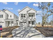 Charming two-story home featuring a white exterior, a balcony and a driveway in front of the garage at 186 Queenview Ln, Charleston, SC 29414
