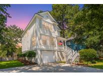 Charming two-story home with a white exterior, lovely front yard, and inviting stairway to the front porch at 1971 N North Creek Dr, Mount Pleasant, SC 29466